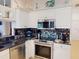 Well-equipped kitchen with stainless steel appliances and white cabinets at 1286 Green Oak Trl, Port Charlotte, FL 33948