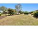 Large backyard featuring mature trees, landscaping and well-maintained lawn at 1364 Ultramarine Ln, Punta Gorda, FL 33983