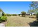 Expansive backyard with lush landscaping and mature trees offering privacy and space at 1364 Ultramarine Ln, Punta Gorda, FL 33983