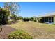 Large grassy backyard with lush tropical landscaping and privacy at 1364 Ultramarine Ln, Punta Gorda, FL 33983