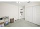 Neutral bedroom featuring carpet, double closet, and connecting doorway to kitchen at 1364 Ultramarine Ln, Punta Gorda, FL 33983