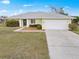 Charming single-story home featuring an attached two-car garage and well-maintained lawn at 1364 Ultramarine Ln, Punta Gorda, FL 33983
