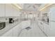 Spacious kitchen with white appliances and cabinets, and tile flooring at 1364 Ultramarine Ln, Punta Gorda, FL 33983