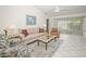 Comfortable living room with tile floors, neutral paint, ceiling fan and sliding glass doors at 1364 Ultramarine Ln, Punta Gorda, FL 33983