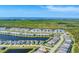 Aerial view of a waterfront residential community featuring multiple gray-roofed buildings and lush green landscaping at 14184 Heritage Landing Blvd # 516, Punta Gorda, FL 33955