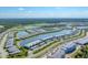 An aerial of homes with gray roofs nestled around a central lake and golf course, surrounded by lush greenery at 14184 Heritage Landing Blvd # 516, Punta Gorda, FL 33955