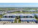 Stunning aerial view of the condominium complex with beautiful landscaping, pond, and community at 14184 Heritage Landing Blvd # 516, Punta Gorda, FL 33955