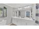 Bathroom features a double vanity, ample lighting, and a shower with a blue and white patterned curtain at 14184 Heritage Landing Blvd # 516, Punta Gorda, FL 33955