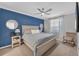 Stylish bedroom with a blue accent wall, comfortable bed, and ample natural light for a peaceful retreat at 14184 Heritage Landing Blvd # 516, Punta Gorda, FL 33955