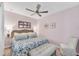 Cozy bedroom featuring a queen bed with floral bedding, wicker headboard and bench at 14184 Heritage Landing Blvd # 516, Punta Gorda, FL 33955