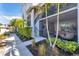 Exterior view of the property showing the entryway, landscaping, palm trees, and staircase at 14184 Heritage Landing Blvd # 516, Punta Gorda, FL 33955
