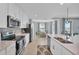 Bright kitchen features white cabinets, stainless steel appliances, and a breakfast nook with natural light at 14184 Heritage Landing Blvd # 516, Punta Gorda, FL 33955