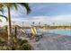 Relaxing poolside lounge chairs under palm trees by the pristine community pool on a clear, sunny day at 14184 Heritage Landing Blvd # 516, Punta Gorda, FL 33955