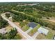 Bird's-eye view of a home with two driveways, complemented by lush surroundings and access to nearby waterways at 1790 New London St, North Port, FL 34288