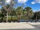 Picturesque scene of a backyard featuring trees with water in the background and dirt in the foreground at 1790 New London St, North Port, FL 34288