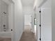 Bright hallway featuring a view into bathroom and bedroom, with modern fixtures at 1790 New London St, North Port, FL 34288