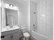 Bathroom featuring a modern vanity, toilet, and tiled shower-tub combination at 1790 New London St, North Port, FL 34288