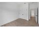 Bedroom with double door closet and views of tile floors and hallway at 1790 New London St, North Port, FL 34288