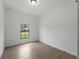 Comfortable bedroom featuring tile flooring, a window view, and neutral wall color at 1790 New London St, North Port, FL 34288