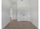 Bedroom featuring double door closet and views of tile floors and hallway at 1790 New London St, North Port, FL 34288