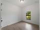 Cozy bedroom featuring tile flooring, a window view, and neutral wall color at 1790 New London St, North Port, FL 34288
