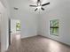 Bedroom with tile floors, a bright window, and access to the hallway at 1790 New London St, North Port, FL 34288