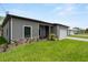 View of the single story home from the side, featuring a well manicured lawn and a 2 car garage at 1790 New London St, North Port, FL 34288