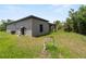 Exterior view of home with lush landscaping, well and pump at 1790 New London St, North Port, FL 34288