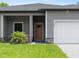 Inviting facade showcasing the front entrance, stone accents, and a well-maintained lawn at 1790 New London St, North Port, FL 34288