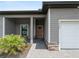 Charming home exterior with a manicured lawn, covered entry and an attached garage at 1790 New London St, North Port, FL 34288
