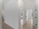 Bright hallway with tile flooring and multiple doorways leading to different rooms at 1790 New London St, North Port, FL 34288