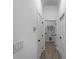 Bright hallway with doors leading to rooms and laundry area with tile flooring and modern switches at 1790 New London St, North Port, FL 34288
