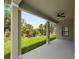 Enjoy the covered outdoor patio with ceiling fan and scenic views of the backyard at 1790 New London St, North Port, FL 34288