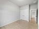 Neutral bedroom with closet and modern flooring, offering ample storage and a clean, minimalist aesthetic at 1818 New London St, North Port, FL 34288