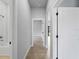 Neutral hallway with a bathroom, showcasing modern ceramic floors, seamless flow and transitions between rooms at 1818 New London St, North Port, FL 34288