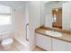 Well-lit bathroom with a shower, toilet, and vanity with sink at 20370 Mount Prospect Ave, Port Charlotte, FL 33952