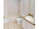 Bright bathroom with a white tiled floor and shower-tub combination at 20370 Mount Prospect Ave, Port Charlotte, FL 33952