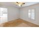 Bright bedroom with a ceiling fan, window with blinds, and neutral carpet at 20370 Mount Prospect Ave, Port Charlotte, FL 33952