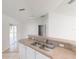 View of the kitchen sink and breakfast bar, leading into the bright and open living area at 20370 Mount Prospect Ave, Port Charlotte, FL 33952