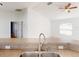 View of the kitchen sink and breakfast bar, leading into the bright and open living area at 20370 Mount Prospect Ave, Port Charlotte, FL 33952