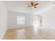 Open concept living area featuring tile floors, a window and a ceiling fan fixture at 20370 Mount Prospect Ave, Port Charlotte, FL 33952