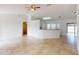 Bright living area with tile floors, ceiling fan fixture, and open layout to the kitchen at 20370 Mount Prospect Ave, Port Charlotte, FL 33952