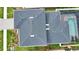 An overhead view of the home, featuring a dark roof, lanai, and screened-in sparkling pool at 2208 Darley Oak Way, North Port, FL 34289
