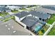 Aerial view of a home with a screened-in pool area, surrounded by lush landscaping, in a serene neighborhood setting at 2208 Darley Oak Way, North Port, FL 34289