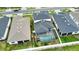 Aerial shot of the backyard featuring a screened-in pool area with white fencing, and green lawn at 2208 Darley Oak Way, North Port, FL 34289