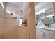 Contemporary bathroom with a tiled shower, rainfall showerhead, and modern fixtures at 2208 Darley Oak Way, North Port, FL 34289