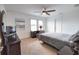 Relaxing bedroom with a ceiling fan, shuttered windows, and space for a home office at 2208 Darley Oak Way, North Port, FL 34289