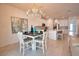Open-concept dining room that features a chandelier and view of the kitchen at 2208 Darley Oak Way, North Port, FL 34289