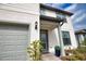 Charming two-story home featuring a gray two-car garage, landscaped yard, and a covered front entryway at 2208 Darley Oak Way, North Port, FL 34289