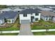 Stunning two-story home with lush landscaping, a paved driveway, and a two-car garage at 2208 Darley Oak Way, North Port, FL 34289
